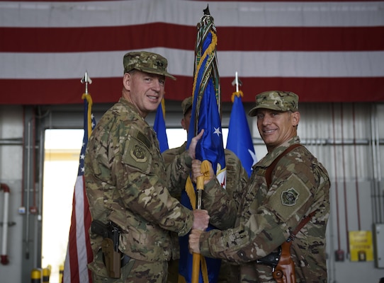 Brig. Gen. Craig Baker, the incoming 455th Air Expeditionary Wing commander, receives the 455th AEW guidon from Maj. Gen. James Hecker, the 9th Air and Space Expeditionary Task Force-Afghanistan commander, which officially grants him command of the 455th AEW during a change of command ceremony at Bagram Airfield, Afghanistan, June 3, 2017. Baker is a command pilot with more than 2,600 flying hours and has commanded at the Squadron and Wing level. (U.S. Air Force photo by Staff Sgt. Benjamin Gonsier)
