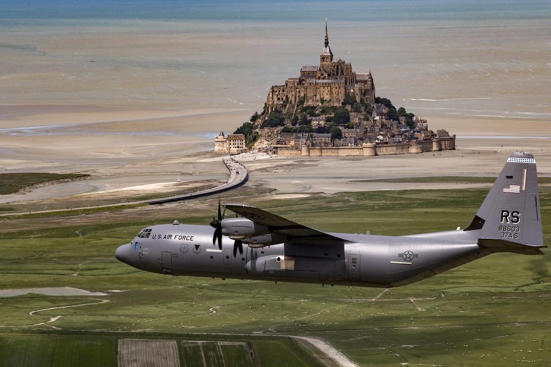 Air Force Brig. Gen. Richard G. Moore Jr. flies a C-130J Super Hercules past Mont Saint-Michel in Normandy, France