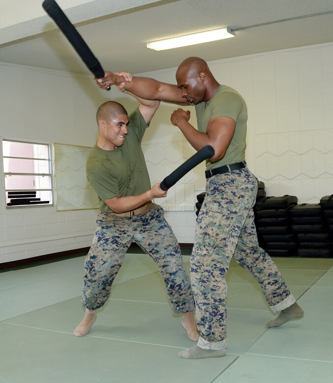 Sgt. Salvador Hernandez, left, martial arts instructor student, conducts a counter to a forward strike technique and then strikes Sgt. Frederick Graham during a Martial Arts Instructor Course aboard Marine Corps Logistics Base Albany, May 17.