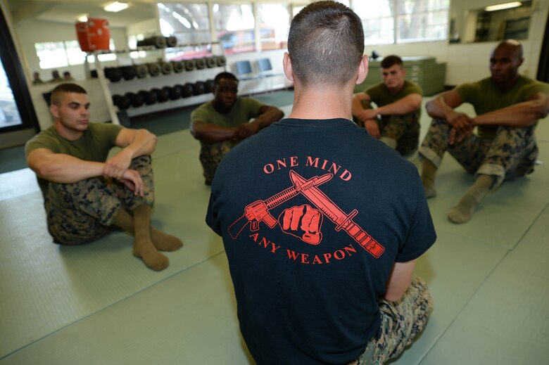 Sgt. James M. Ahearn, center, martial arts instructor trainer, Marine Corps Logistics Base Albany, discusses a warrior study with his students during a Martial Arts Instructor Course aboard Marine Corps Logistics Base Albany, May 17.