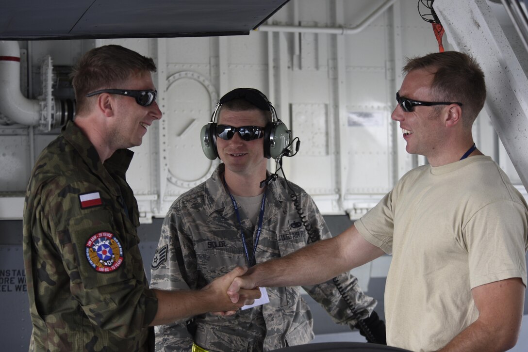 Master Sgt. Jacob Wavrin, right, 459th Aircraft Maintenance Squadron crew chief, along with Staff Sgt. James Sidler, center, 459th AMXS aircraft mechanic, talk with Polish air force Staff Sgt. Radoslaw Tyc, left, during BALTOPS exercise at Powidz Air Base, Poland, June 5, 2017. BALTOPS is an annually recurring multinational exercise designed to enhance flexibility and interoperability, as well as demonstrate resolve of allied and partner forces to defend the Baltic region. Participating nations include Belgium,
Denmark, Estonia, Finland, France, Germany, Latvia, Lithuania, the Netherlands, Norway, Poland, Sweden, the United Kingdom, and the United States. (U.S. Air Force photo by Staff Sgt. Jonathan Snyder)