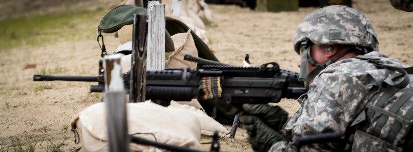 A drill sergeant from the 1st Battalion, 304th Infantry Regiment engages a target with an M249 Squad Automatic Weapon during weapons familiarization training at Fort Devens, MA. Soldiers exercised their expertise and trained Navy junior officers during a joint training exercise June 3, 2017.