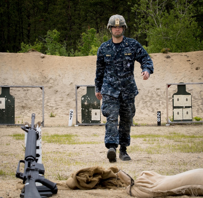 Ensign David Segala, an Engineer Duty Officer from New London, CT walks back to his rifle after checking his target on a Zero Range at Fort Devens, MA. Navy junior officers participated in joint training with Army drill sergeants to enhance unit and individual readiness for future deployments June 3, 2017.