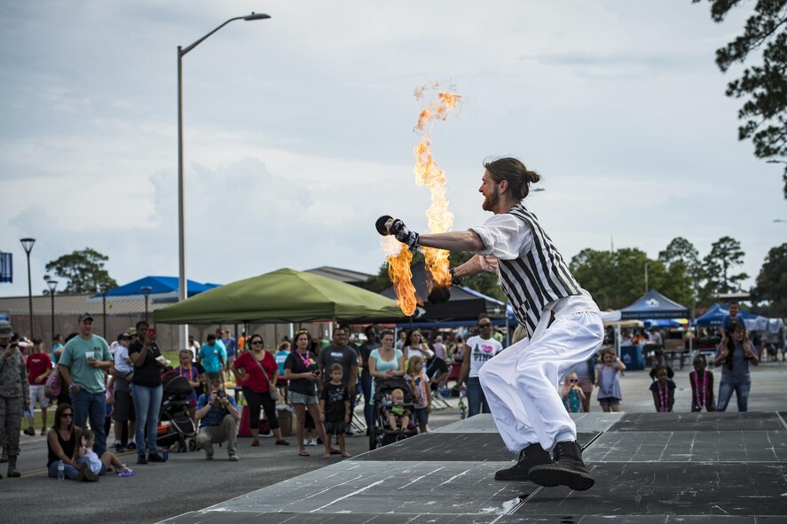 Charlie Wickboldt, a fire performer, dances with fire during the Moody Summer Block Party, June 2, 2017, at Moody Air Force Base, Ga. Members of Team Moody were encouraged to attend the event which offered a plethora of activities for all ages, including water slides, volleyball tournaments, a car show, and live entertainment. (U.S. Air Force photo by Senior Airman Janiqua P. Robinson)