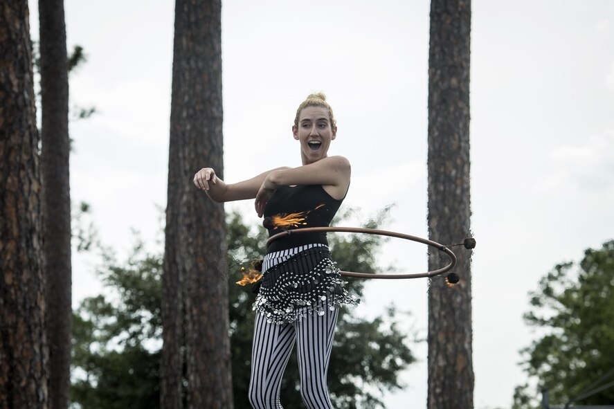 Staci Stander, a fire performer, dances in a ring of fire during the Moody Summer Block Party, June 2, 2017, at Moody Air Force Base, Ga. Members of Team Moody were encouraged to attend the event which offered a plethora of activities for all ages, including water slides, volleyball tournaments, a car show, and live entertainment. (U.S. Air Force photo by Senior Airman Janiqua P. Robinson)