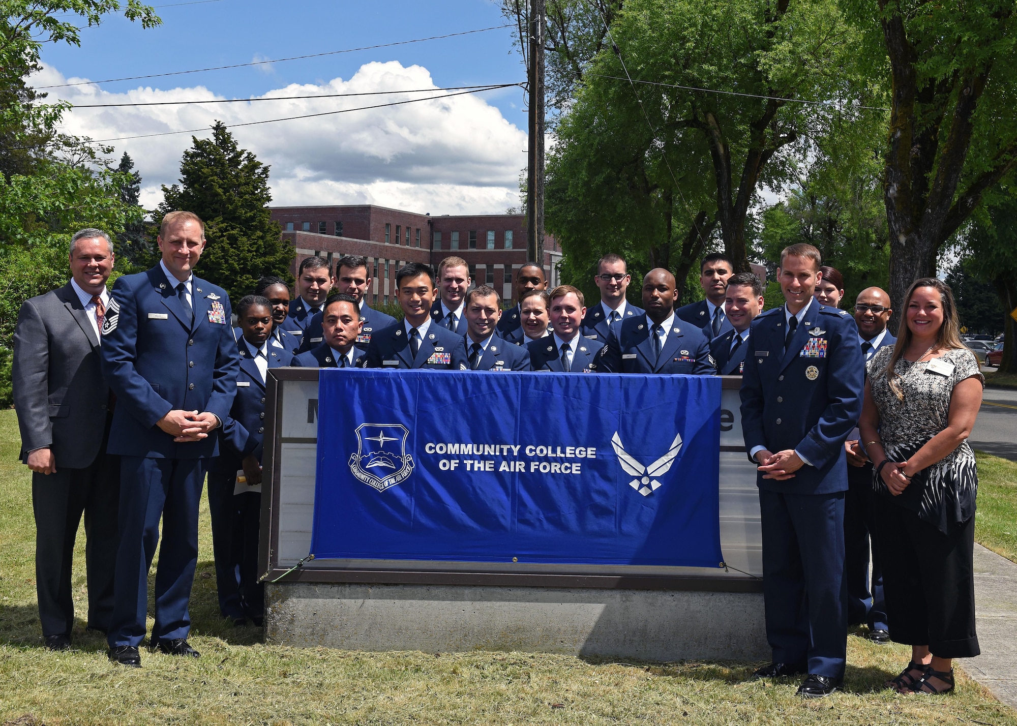 Graduates of the Community College of the Air Force stand with distinguished guests following a commencement ceremony, June 2, 2017 at the McChord Theater at Joint Base Lewis-McChord, Wash. The CCAF provides Airmen an opportunity to leverage their military training toward furthering their education. (U.S. Air Force photo/Staff Sgt. Whitney Taylor)