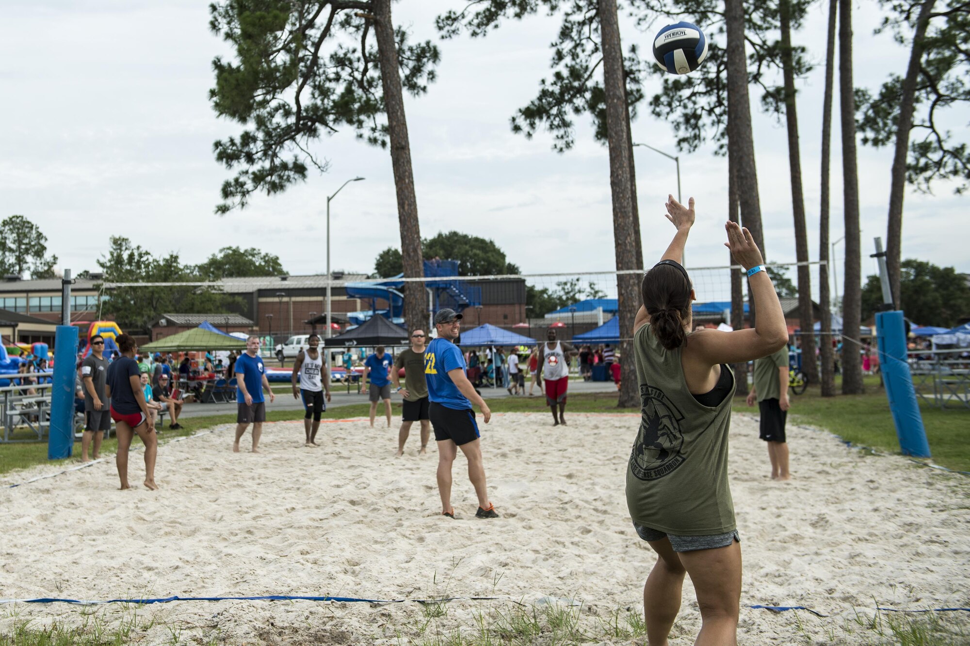 A competitor serves a volleyball during the tournament portion of the Moody Summer Block Party, June 2, 2017, at Moody Air Force Base, Ga. Members of Team Moody were encouraged to attend the event which offered a plethora of activities for all ages, including water slides, volleyball tournaments, a car show, and live entertainment. (U.S. Air Force photo by Senior Airman Janiqua P. Robinson)