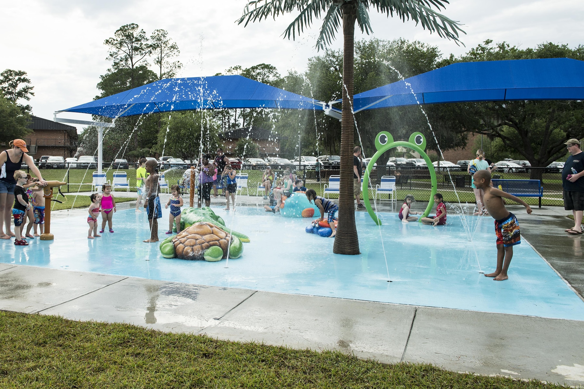 Attendees play on a splash pad during the Moody Summer Block Party, June 2, 2017, at Moody Air Force Base, Ga. Members of Team Moody were encouraged to attend the event which offered a plethora of activities for all ages, including water slides, volleyball tournaments, a car show, and live entertainment. (U.S. Air Force photo by Senior Airman Janiqua P. Robinson)
