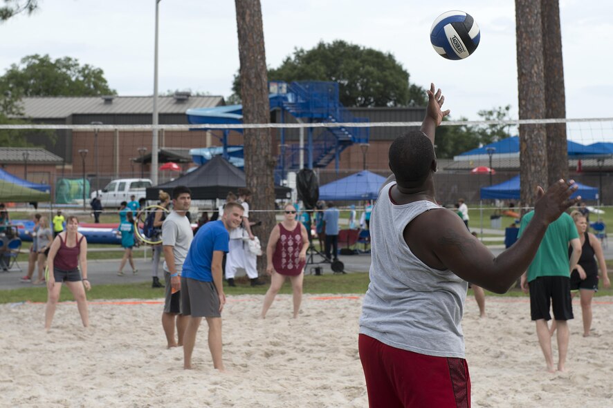 A participant prepares to serve in a volleyball game during the Moody Summer Block Party, June 2, 2017, at Moody Air Force Base, Ga. Volleyball was one of the several activities available to Team Moody members during the event. (U.S. Air Force photo by Airman 1st Class Erick Requadt)