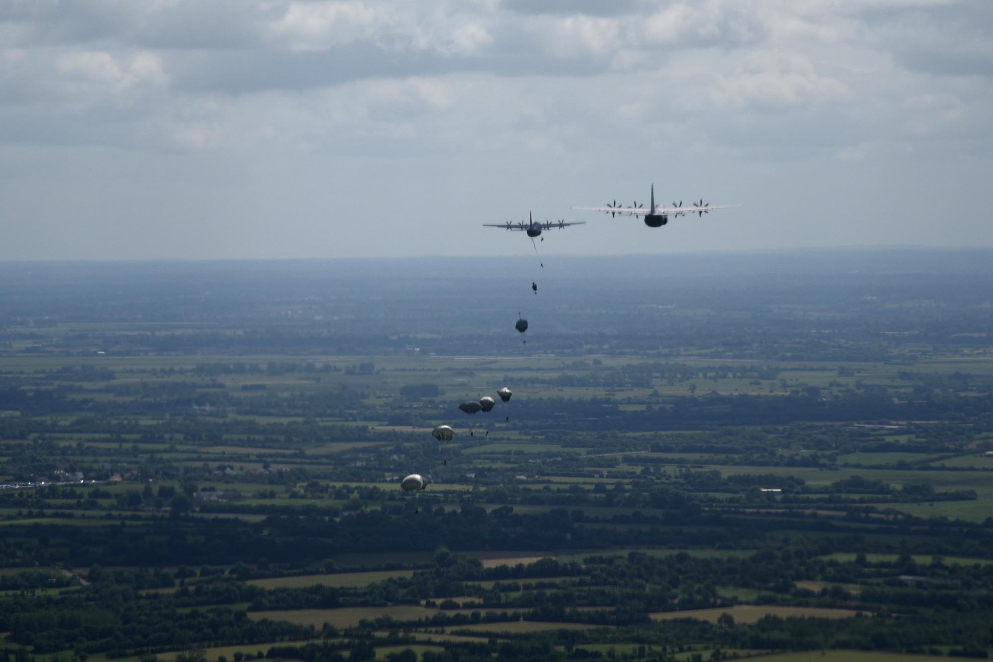 Paratroops jump from C-130J aircraft during a six-ship troop drop over Normandy, France. This event commemorates the 73rd anniversary of D-Day, the largest multi-national amphibious landing and operational military airdrop in history, and highlights the U.S.' steadfast commitment to European allies and partners. Overall, approximately 400 U.S. service members from units in Europe and the U.S. are participating in ceremonial D-Day events from May 31 to June 7, 2017(U.S. Air Force photo by Staff Sgt. Nicholas Monteleone)