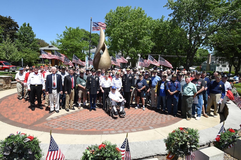 The veterans of Arlington Heights pause for a photo with U.S. Army Reserve Brig. Gen. Frederick R. Maiocco Jr., (center right) Commanding General, 85th Support Command, and Command Sgt. Maj. Vernon Perry III (center left) Command Sergeant Major, 85th Support Command, in front of the Eternal Flame at Memorial Park in Arlington Heights, Illinois, May 29, 2017. The group gathered for a photo after the conclusion of the Memorial Day commemoration. 
(U.S. Army photo by Sgt. Aaron Berogan/Released)