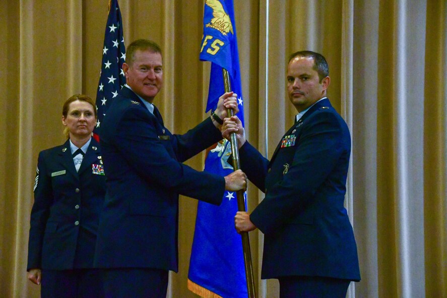 Col. William Rock, 307th Mission Support Group commander, passes the 307th Security Forces Squadron guidon to Capt. Joel Brown during an assumption of command ceremony on Barksdale Air Force Base, La., June 4, 2017. Brown is assuming command of the 307th SFS and brings additional experience to the unit from serving both as an enlisted Airman and an Army officer. (U.S. Air Force photo by Master Sgt. Dachelle Melville/Released)