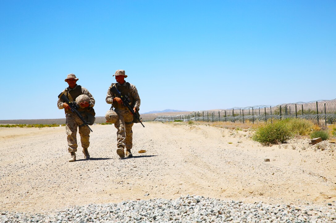 Marines with Marine Wing Support Squadron (MWSS) 373 return from their guard post and prepare to conduct an area damage assessment as part of the base recovery after attack training (BRAAT) evolution during Integrated Training Exercise (ITX) 3-17 at Marine Corps Air Ground Combat Center Twentynine Palms, Calif., May 23. ITX is a combined-arms exercise enabling Marines across 3rd Marine Aircraft Wing to operate as an aviation combat element integrated with ground and logistics combat elements as a Marine air-ground task force. More than 650 Marines and 27 aircraft with 3rd MAW are supporting ITX 3-17. (U.S. Marine Corps photo by Sgt. David Bickel/Released)