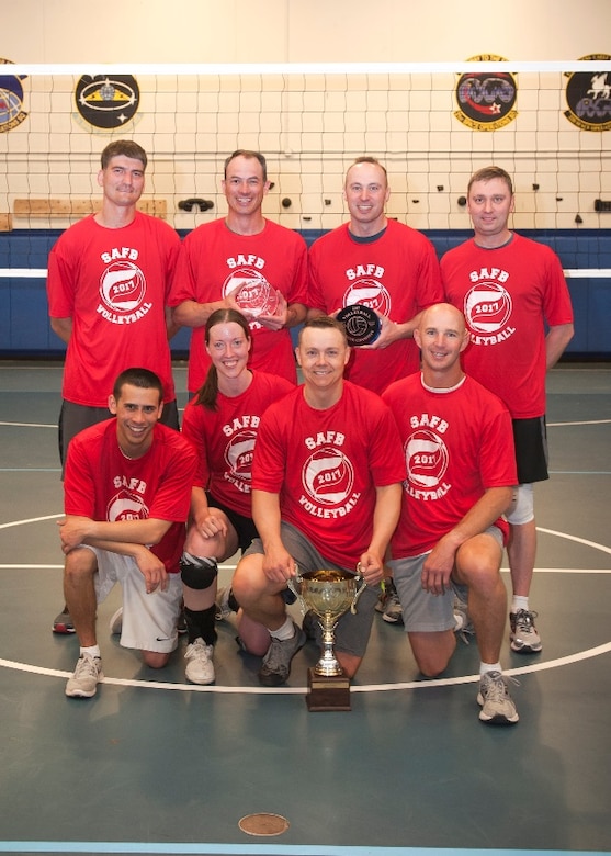 310th Operations Group volleyball team members gather for a photo after their victory during the 13th annual Schriever Intramural Volleyball Championship in the fitness center at Schriever Air Force Base, Colorado, Wednesday, May 31, 2017. The team defeated the 3rd Space Operations Squadron 2-1.  (U.S. Air Force Photo/Dennis Rogers)
