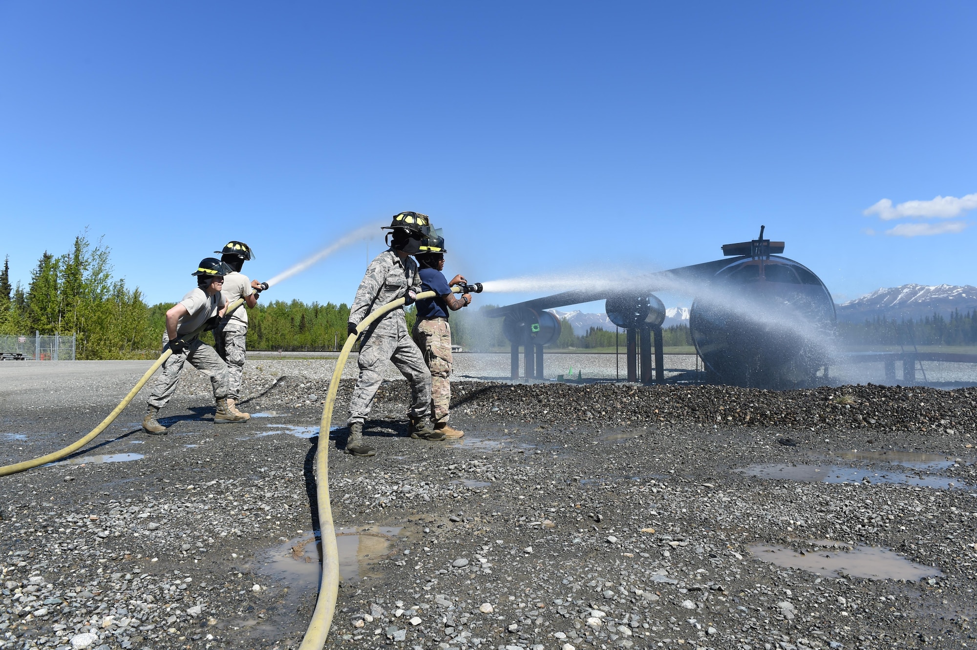 East, Bartlett, and Colony high school Junior ROTC cadets extinguish a simulated fire at the fire training area at Joint Base Elmendorf-Richardson, May 30, 2017. 