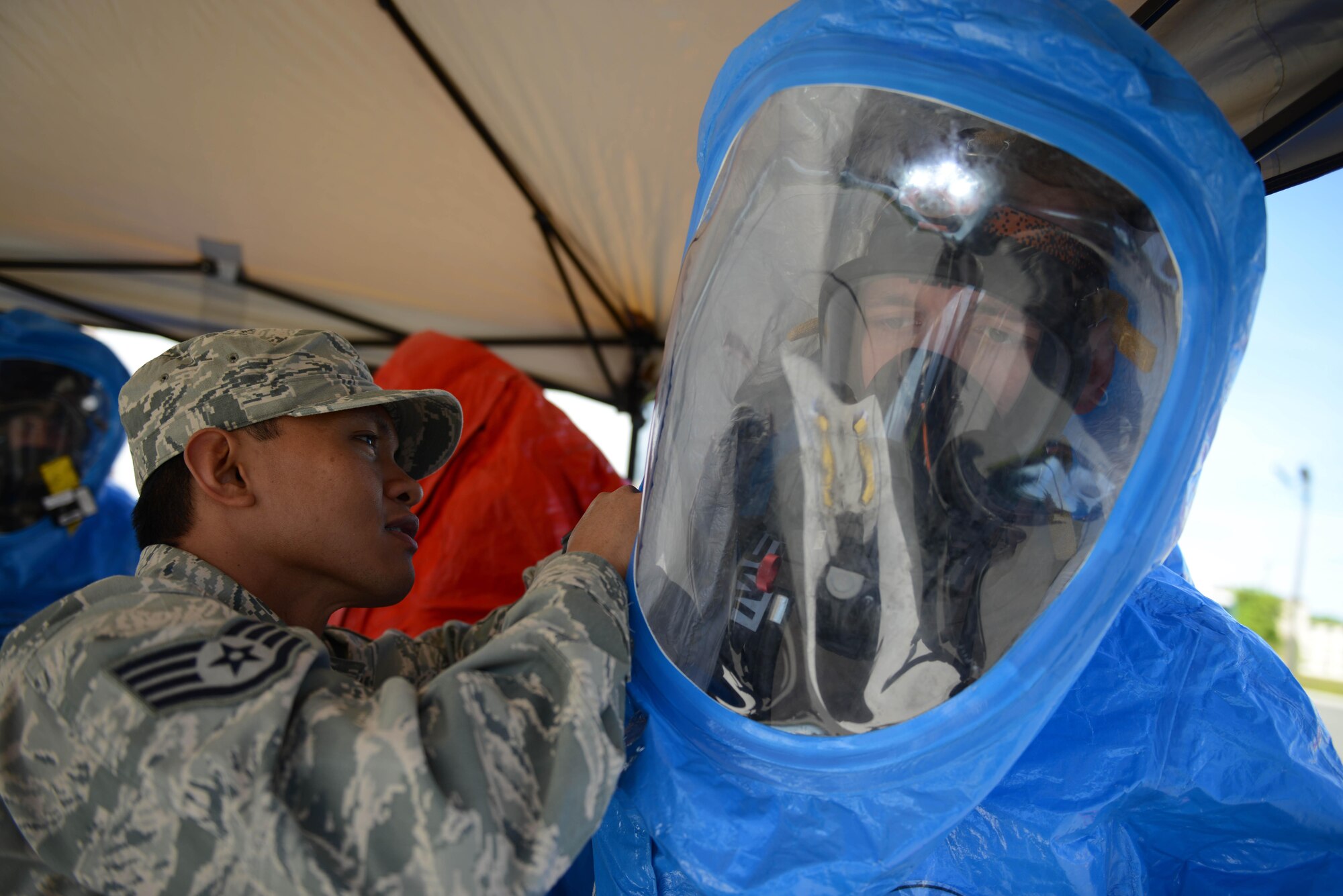 Airmen of the 673d Aerospace Medical Squadron don their hazardous material suits at the Talkeetna Theater during a Mission Assurance Exercise, June 1, 2017. The exercise tested the installation’s capabilities in dealing with a simulated anthrax attack.