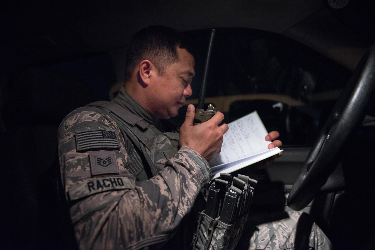 U.S. Air National Guard Staff Sgt. Melquiadez Racho, a patrol team lead with the 407th Expeditionary Security forces Squadron, uses his radio to check in with the base defense operations center May 13, 2017, in Southwest Asia. During patrols, security forces defenders perform safety and welfare checks across base and check base fencelines and perimeters for anomalies. Racho is a traditional guardsman deployed from the 254th Security Forces Squadron at Andersen Air Force Base, Guam. When not on Air Force orders, Racho serves as a police instructor with the Department of Defense on Guam. (U.S. Air Force photo by Staff Sgt. Alexander W. Riedel)