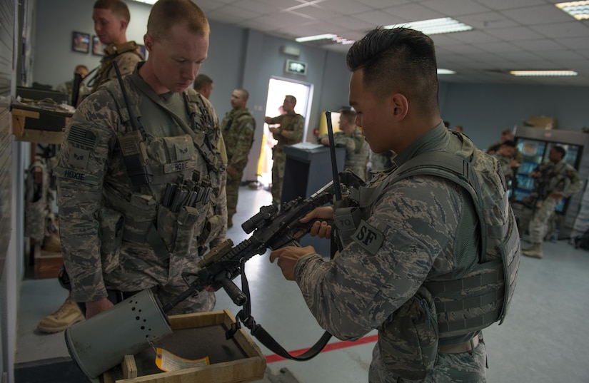 U.S. Air National Guard Airman 1st Class Randall Diego, a security forces member with the 407th Expeditionary Security Forces Squadron, inserts a magazine into his M4 carbine at the beginning of his guard shift May 13, 2017. Diego is a member of the 254th Security Forces Squadron at Andersen Air Force Base and volunteered for his first deployment right out of technical training. He is part of a team of Guam service members who deployed together in support of Operation Inherent Resolve. (U.S. Air Force photo by Staff Sgt. Alexander W. Riedel)