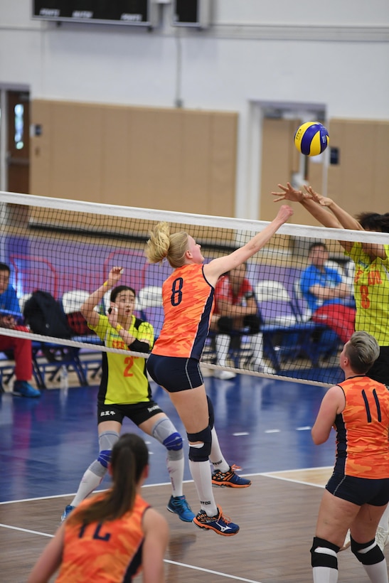 Dutch middle blocker Katelijne Van Houten spikes over her Chinese opponents in match 3 of the 18th Conseil International du Sport Militaire (CISM) World Women's Military Volleyball Championship at Naval Station Mayport, Florida on 5 June 2017. Mayport is hosting the CISM Championship from 2-11 June.  Finals are on 9 June.
