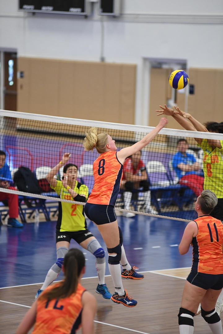 Dutch middle blocker Katelijne Van Houten spikes over her Chinese opponents in match 3 of the 18th Conseil International du Sport Militaire (CISM) World Women's Military Volleyball Championship at Naval Station Mayport, Florida on 5 June 2017. Mayport is hosting the CISM Championship from 2-11 June.  Finals are on 9 June.