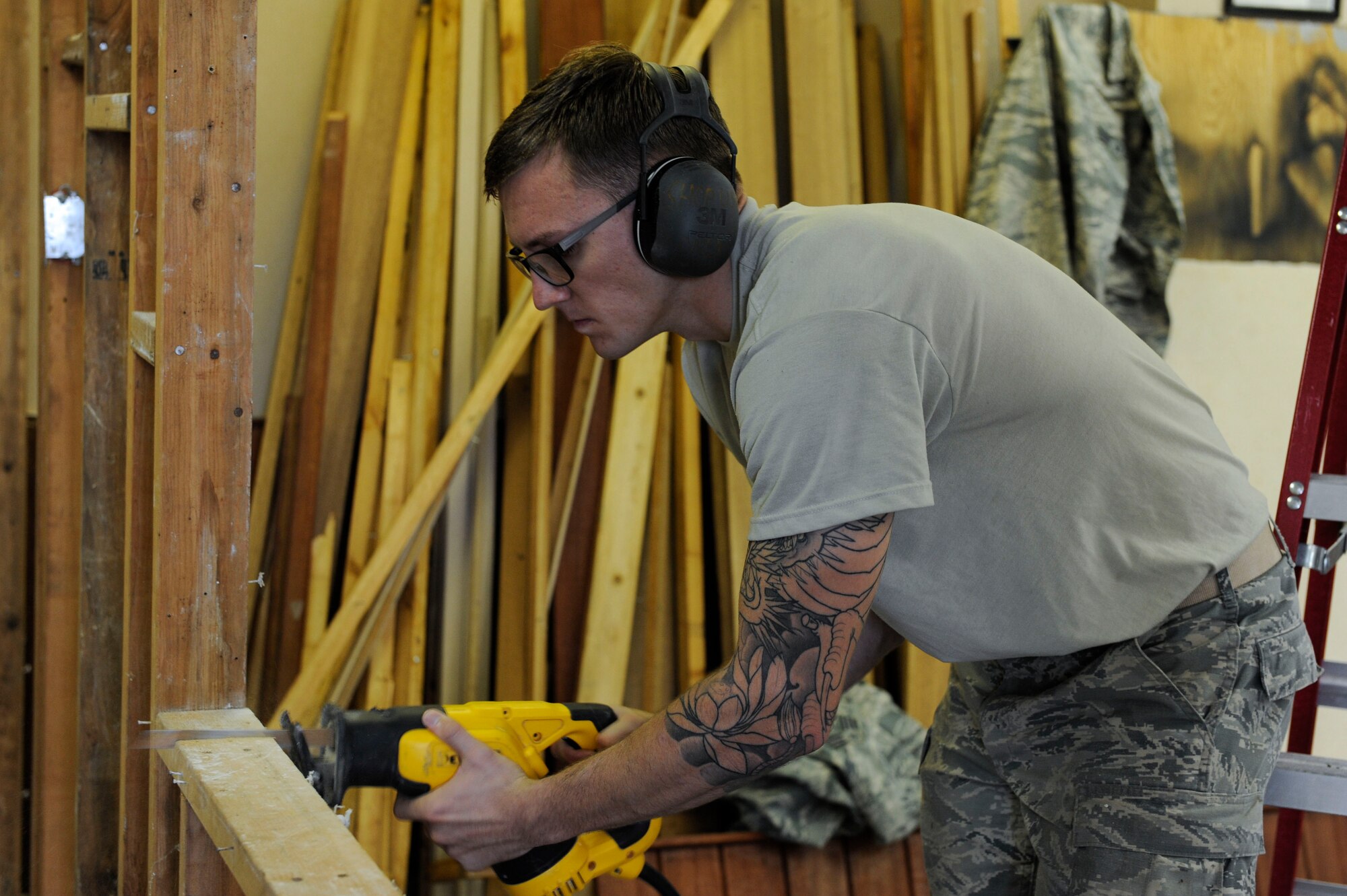 U.S. Air Force Airman 1st Class Kaden Petersen, 18th Civil Engineer Squadron structural apprentice, uses a reciprocating saw to cut off part of a wall frame at the 961st Airborne Air Control Squadron May 17, 2017, at Kadena Air Base, Japan. Projects involving the 18th CES structures Airmen include deconstructing wall frames to make more space for mission meetings. (U.S. Air Force photo by Senior Airman Lynette M. Rolen)