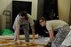 U.S. Air Force Airmen 1st Class Kaden Petersen and Joseph Carswell, 18th Civil Engineer Squadron structural apprentices, lay down part of a wall frame as part of a workspace expansion project at the 961st Airborne Air Control Squadron May 17, 2017, at Kadena Air Base, Japan. Using proper safety techniques for moving equipment and materials is important for prevention of workplace injuries. (U.S. Air Force photo by Senior Airman Lynette M. Rolen)