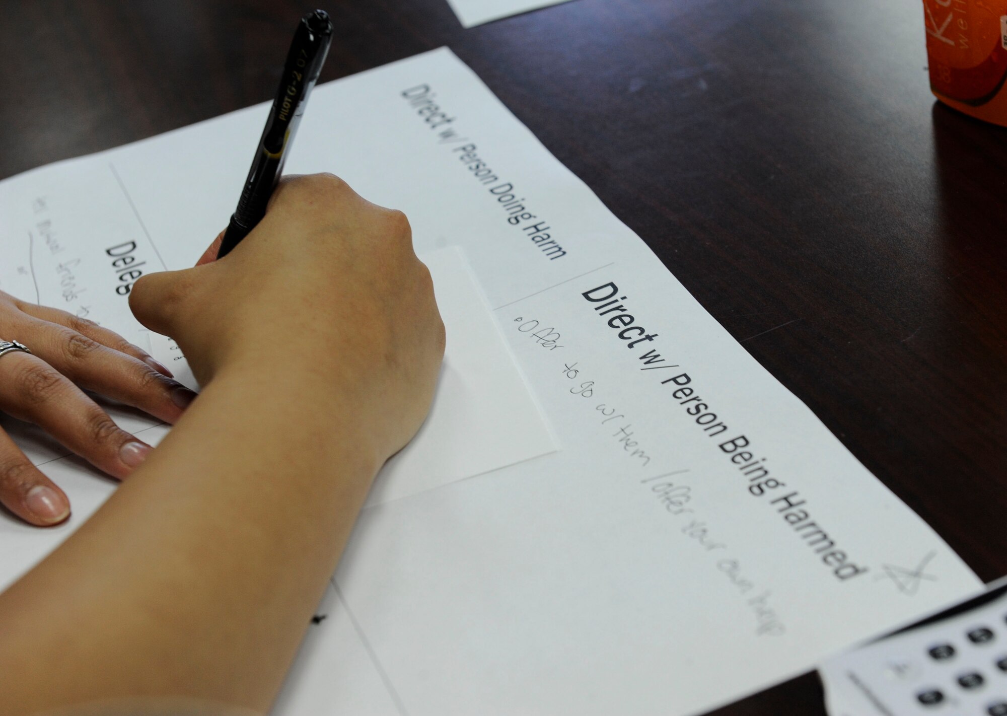 U.S. Air Force Airman 1st Class Cinthya Barber, 353rd Special Operations Maintenance Squadron maintenance management analysis apprentice, writes down a response to a question posed during Green Dot Key Influencer Training May 24, 2017, at Kadena Air Base, Japan. Participants in the Key Influencer Training were encouraged to think of the best personal response for preventing power-based interpersonal violence. (U.S. Air Force photo by Senior Airman Lynette M. Rolen)