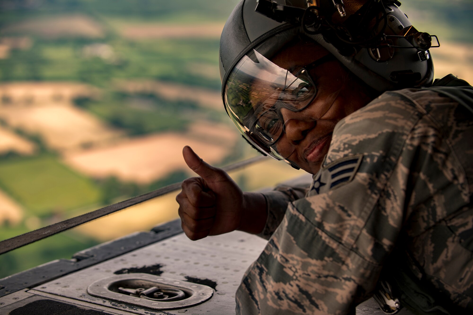 U.S. Air Force Senior Airman Chasady Harris, 86th Operations Support Squadron aircrew flight equipment journeyman, gives a “thumbs up” while laying on the ramp of a C-130J Super Hercules assigned to the 37th AS at Ramstein Air Base, Germany, during a flyover in Normandy, France, June 2, 2017. The flyover commemorates the 73rd anniversary of D-Day, the largest multinational amphibious landing and operational military airdrop in history, and highlights the U.S.' steadfast commitment to European allies and partners. Overall, approximately 400 U.S. service members from units in Europe and the U.S. are participating in ceremonial D-Day 73 events from May 31-June 7, 2017. (U.S. Air Force photo by Senior Airman Devin Boyer)