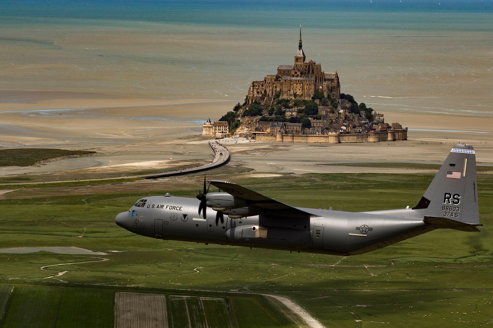 U.S. Air Force Brig. Gen. Richard G. Moore Jr., 86th Airlift Wing commander, flies a C-130J Super Hercules assigned to the 37th Airlift Squadron at Ramstein Air Base, Germany, past Mont Saint-Michel, France, June 3, 2017. This event commemorates the 73rd anniversary of D-Day, the largest multinational amphibious landing and operational military airdrop in history, and highlights the U.S.' steadfast commitment to European allies and partners. Overall, approximately 400 U.S. service members from units in Europe and the U.S. are participating in ceremonial D-Day 73 events from May 31-June 7, 2017. (U.S. Air Force photo by Senior Airman Devin Boyer)