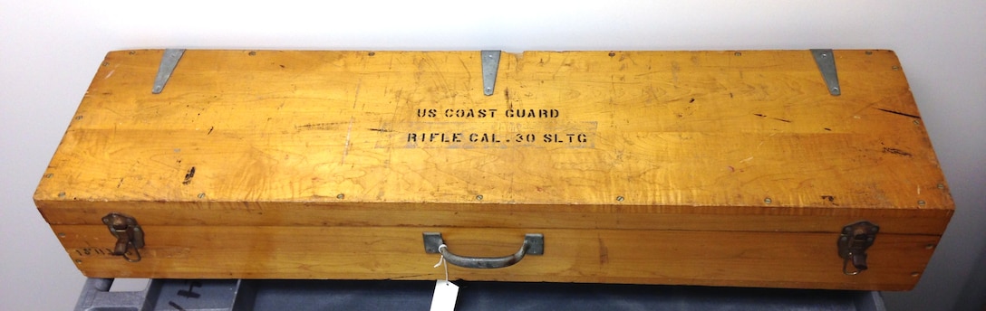 Line throwing rifle, Springfield model 1903 manufactured by the W. H. Reisner MFG. Co., Inc., Hagerstown, MD consisting of cast and carved rifle with attached canister, case, and accessories; rifle and canister (2), carrying case (1), 13 oz light projectiles (5), 15 oz heavy projectiles painted red (3), 15 oz heavy projectile unpainted (1), 1 complete buoyant projectile (1), 2 buoyant projectiles in pieces (4), unused nylon line (4), wooden mallet (1), cleaning rod (1), bag of muslin patches for cleaning (1), bag of cleaning supplies (22), bottle of weapons oil (1), and pair of goggles (1). All items in original wooden case with metal latches and painted labels and warnings with 2 metal latches on the front and handle for carrying. Rifle is marked "U.S. Springfield Armory Model 1903 1316819" and case has plastic plaque "W. H. Reisner MFG., Co., Inc. Hagerstown, MD Contract No. 735CG-1512-B".
Heritage Asset Collection, 2014.003.001