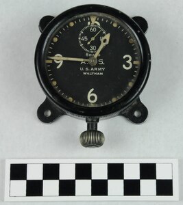 Clock, small aviator's, made of black metal with luminous dial with white numbering, dots, and notches and with "8 Days A.S. US Army Waltham" with white clock hands and with hand knob at bottom and frame on back with 4 holes for mounting, with hand engraved markings on the back "47AGV" and "32381".  Made by Waltham.  Used by Coast Guard Warrant Officer Cadmus Daniel Griffin, WWI.
Heritage Asset Collection, 2014.024.009