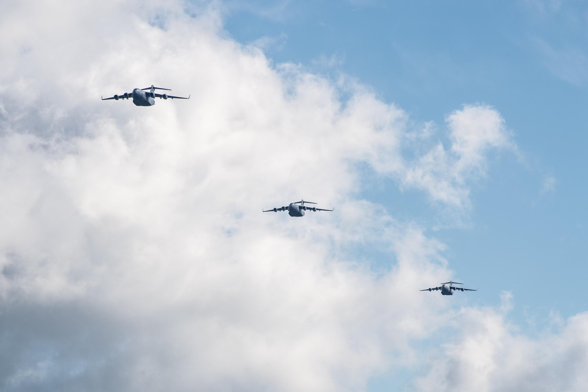 POPE ARMY AIRFIELD, N.C. -- Three C-17 Globemaster IIIs from the 437th Airlift Wing at Joint Base Charleston, S.C., fly in formation over the flightline here May 25 during the 82nd Airborne Division's All American Week. The 43d Air Mobility Operations Group supported the 82nd and visiting Air Mobility Command aircrews as they prepared for the annual All American Week airdrop at Sicily Drop Zone on Fort Bragg. The drop was cancelled due to high winds after the aircraft launched from Pope Field. (U.S. Air Force photo/Marc Barnes)