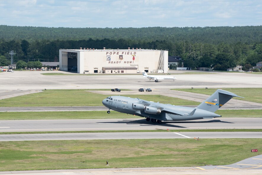 POPE ARMY AIRFIELD, N.C. -- A C-17 Globemaster III from the 437th Airlift Wing at Joint Base Charleston, S.C., launches from the runway here May 25 during the 82nd Airborne Division's All American Week. The 43d Air Mobility Operations Group supported the 82nd and visiting Air Mobility Command aircrews as they prepared for the annual All American Week airdrop at Sicily Drop Zone on Fort Bragg. The drop was cancelled due to high winds after the aircraft launched from Pope Field. (U.S. Air Force photo/Marc Barnes)