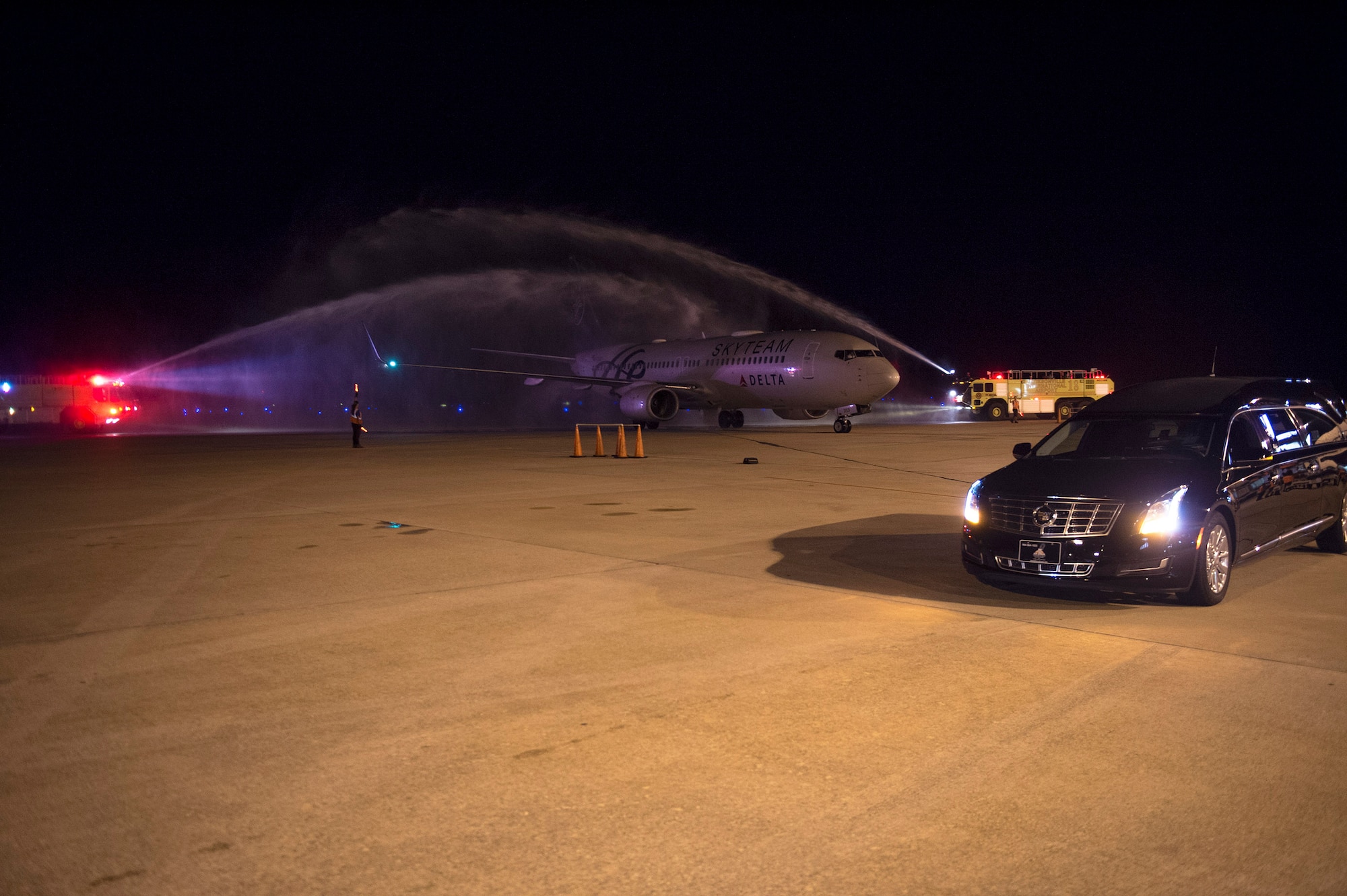 Water overarches an aircraft during a dignified arrival for deceased Senior Airman Gabriel Antonio Fuentes Lebrón, 18th Security Forces Squadron, Kadena Air Base, Japan, in Jacksonville, Fla., May 30, 2017. A dignified arrival is the process by which, upon the return from the theater of operations to the United States, the remains of fallen military members are transferred from an aircraft to a waiting vehicle and then to the port mortuary. Lebrón passed away in Okinawa, May 19. (U.S. Air Force photo by Senior Airman Greg Nash) 