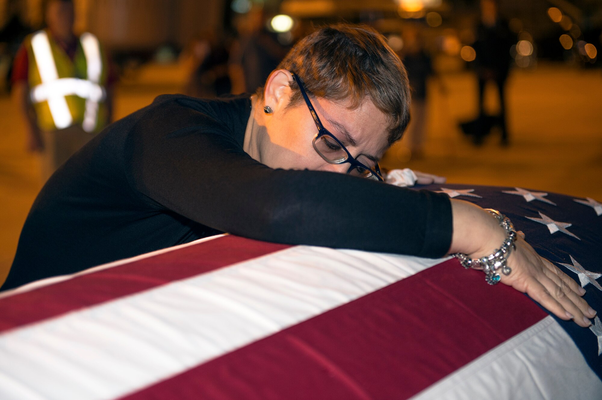 Maribel Lebrón hugs her son’s, Senior Airman Gabriel Antonio Fuentes Lebrón, 18th Security Forces Squadron, Kadena Air Base, Japan, casket during his dignified arrival in Jacksonville, Fla., May 30, 2017. A dignified arrival is the process by which, upon the return from the theater of operations to the United States, the remains of fallen military members are transferred from an aircraft to a waiting vehicle and then to the port mortuary. Lebrón passed away in Okinawa, May 19. (U.S. Air Force photo by Senior Airman Greg Nash)