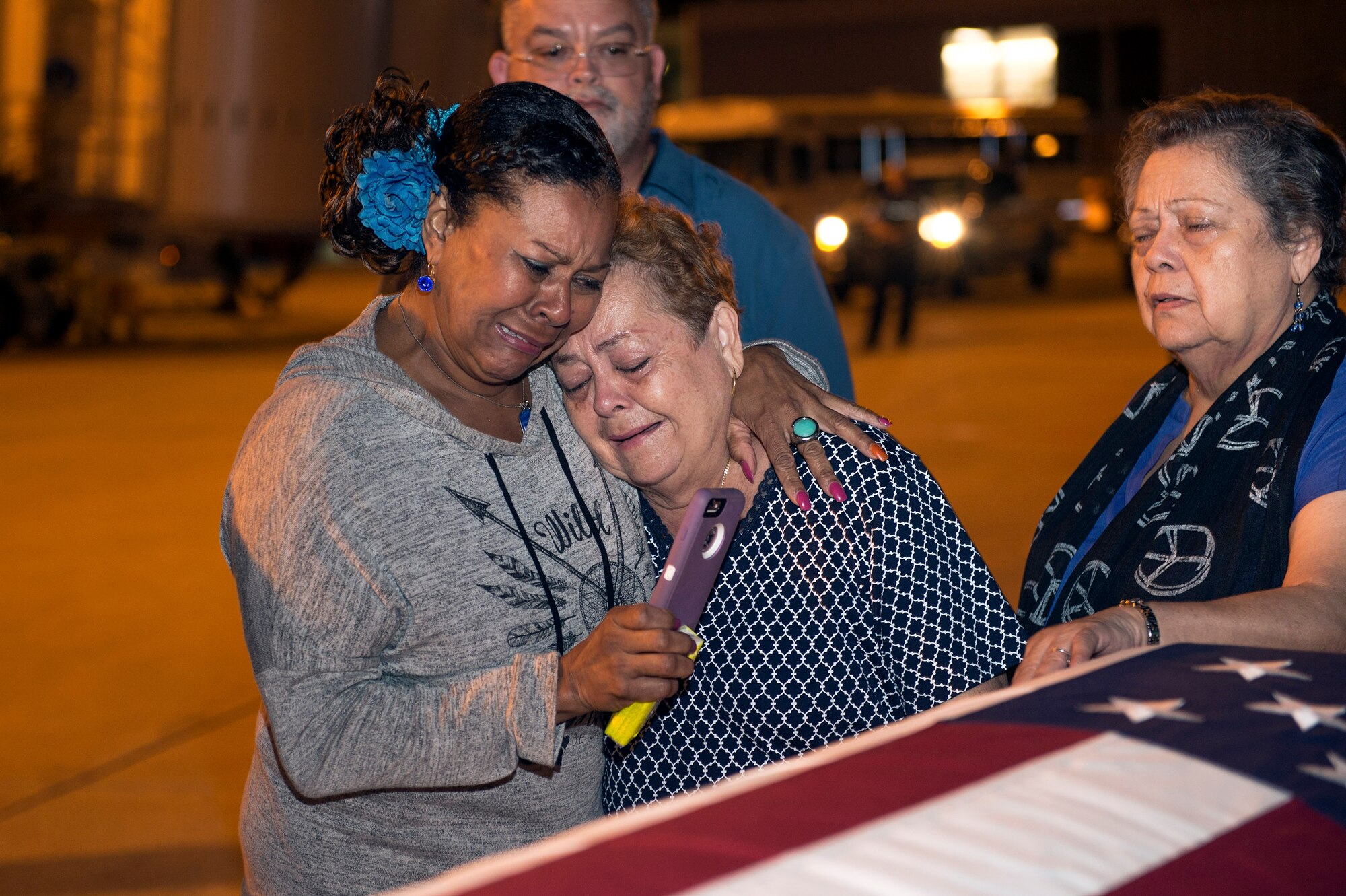 Family members mourn during a dignified arrival for deceased Senior Airman Gabriel Antonio Fuentes Lebrón, 18th Security Forces Squadron, Kadena Air Base, Japan, in Jacksonville, Fla., May 30, 2017. A dignified arrival is the process by which, upon the return from the theater of operations to the United States, the remains of fallen military members are transferred from an aircraft to a waiting vehicle and then to the port mortuary. Lebrón passed away in Okinawa, May 19. (U.S. Air Force photo by Senior Airman Greg Nash)