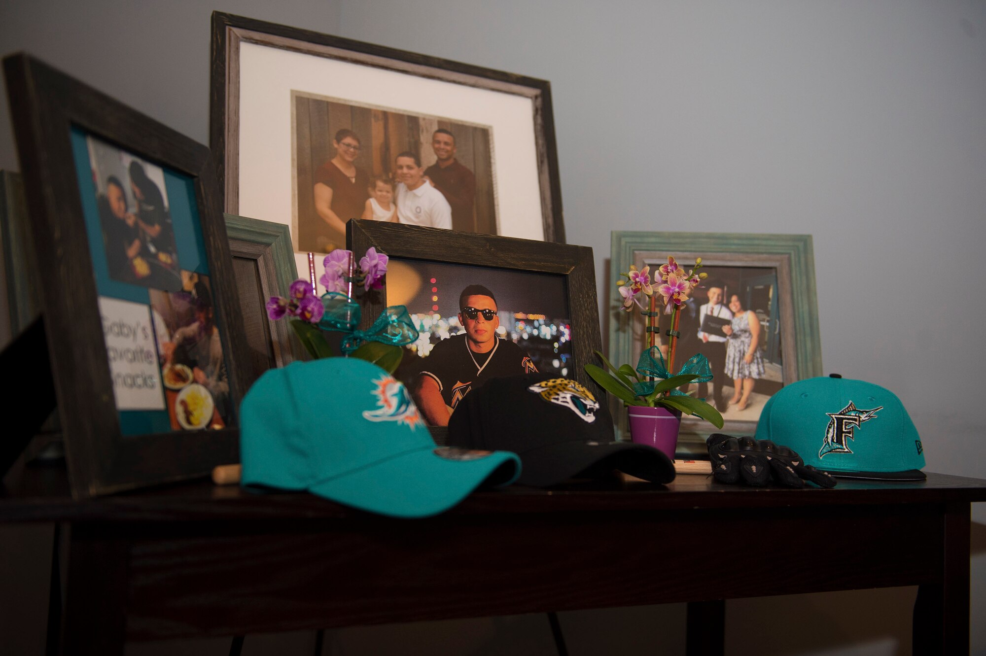 Photos honoring deceased Senior Airman Gabriel Antonio Fuentes Lebrón, 18th Security Forces Squadron, Kadena Air Base, Japan, rest on display during his funeral in Orange Park, Fla., June 1, 2017. His most recent accomplishment was being selected for promotion to Senior Airman Below The Zone, March 23, and was posthumously promoted on the day of his passing, May 19. He leaves behind his parents, older brother, Miguel Angel, sisters Michelle and Valerie, niece, Ileana, as well as countless family members and friends. (U.S. Air Force photo by Senior Airman Greg Nash)