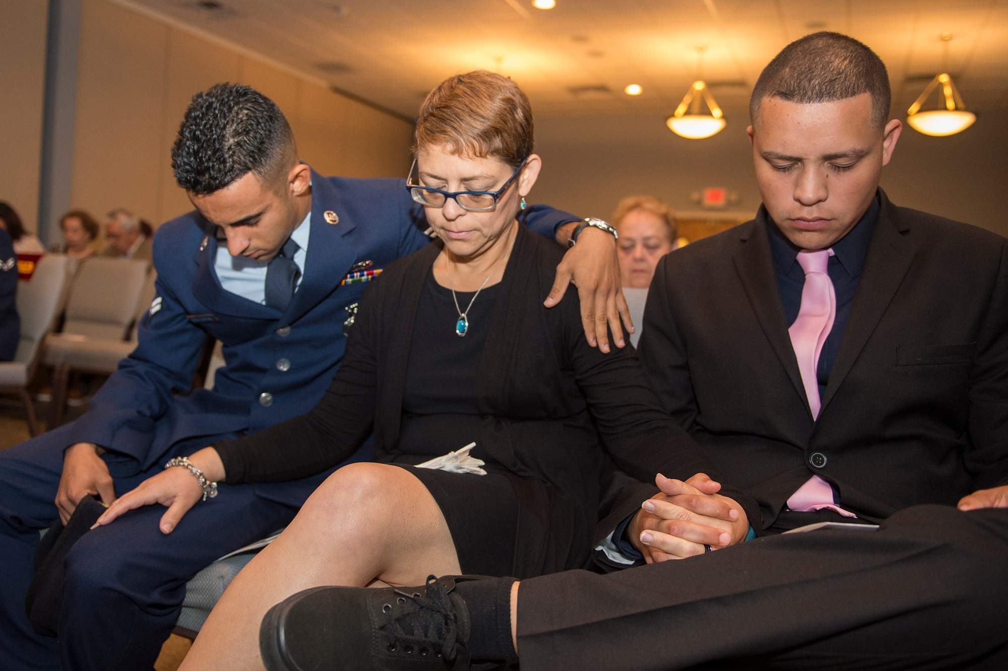 Mourners pray during a funeral for deceased Senior Airman Gabriel Antonio Fuentes Lebron’s, 18th Security Forces Squadron, Kadena Air Base, Japan, in Orange Park, Fla., June 1, 2017. Lebron’s most recent accomplishment was being selected for promotion to Senior Airman Below The Zone, March 23, and was posthumously promoted on the day of his passing, May 19. He leaves behind his parents, older brother, Miguel Angel, sisters Michelle and Valerie, niece, Ileana, as well as countless other family members and friends. (U.S. Air Force photo by Senior Airman Greg Nash)