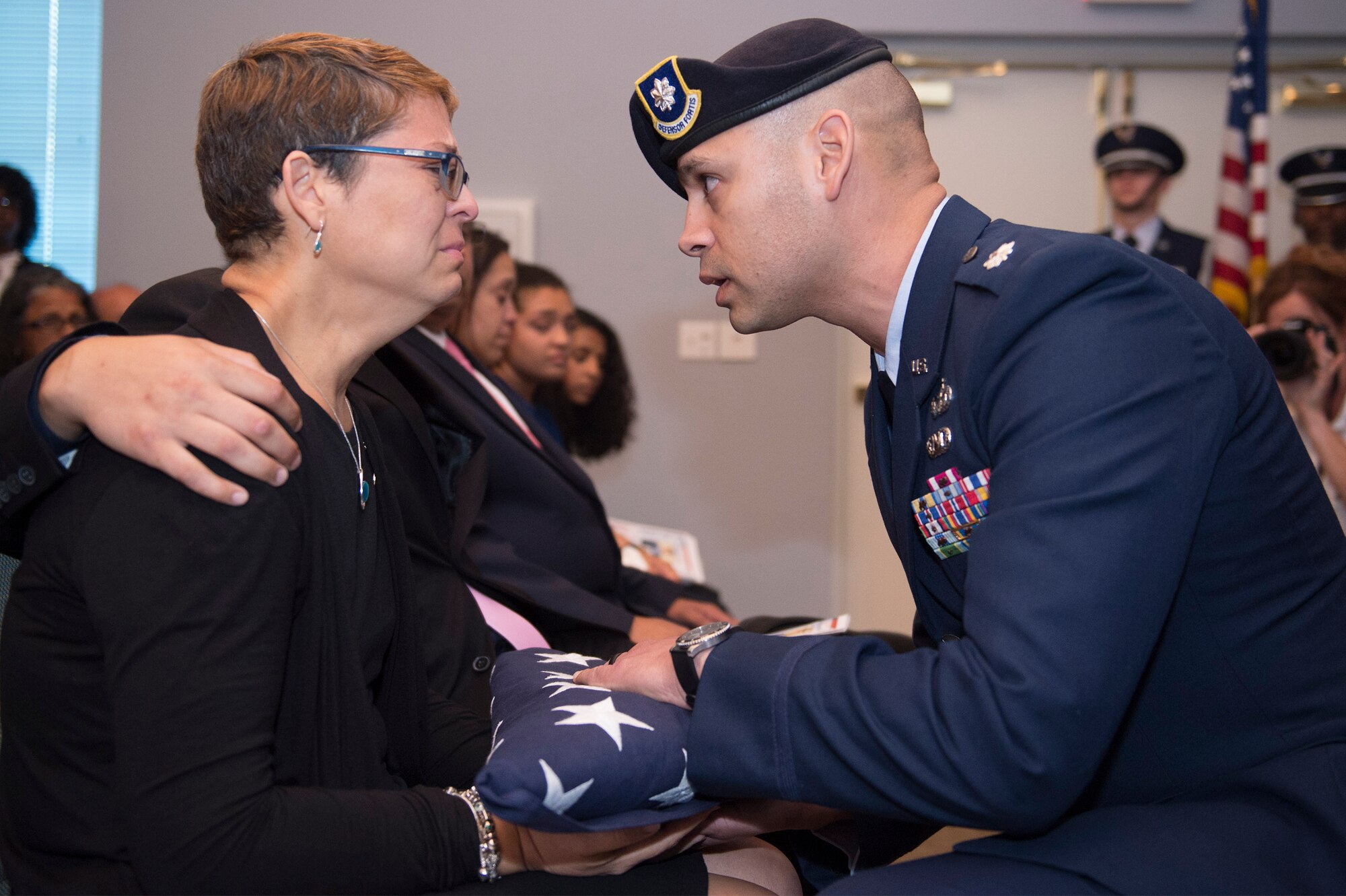 Lt. Col. José Antonio Lebrón, Joint Task Force-Bravo, joint security forces commander, Soto Cano Air Base, Honduras, presents Maribel Lebrón, mother of deceased Senior Airman Gabriel Antonio Fuentes Lebrón, 18th Security Forces Squadron, Kadena Air Base, Japan, with a flag during a funeral in Orange Park, Fla., June 1, 2017. Lebrón’s most recent accomplishment was being selected for promotion to Senior Airman Below The Zone, March 23, and was posthumously promoted on the day of his passing, May 19. He leaves behind his parents, older brother, Miguel Angel, sisters Michelle and Valerie, niece, Ileana, as well as countless other family members and friends. (U.S. Air Force photo by Senior Airman Greg Nash)