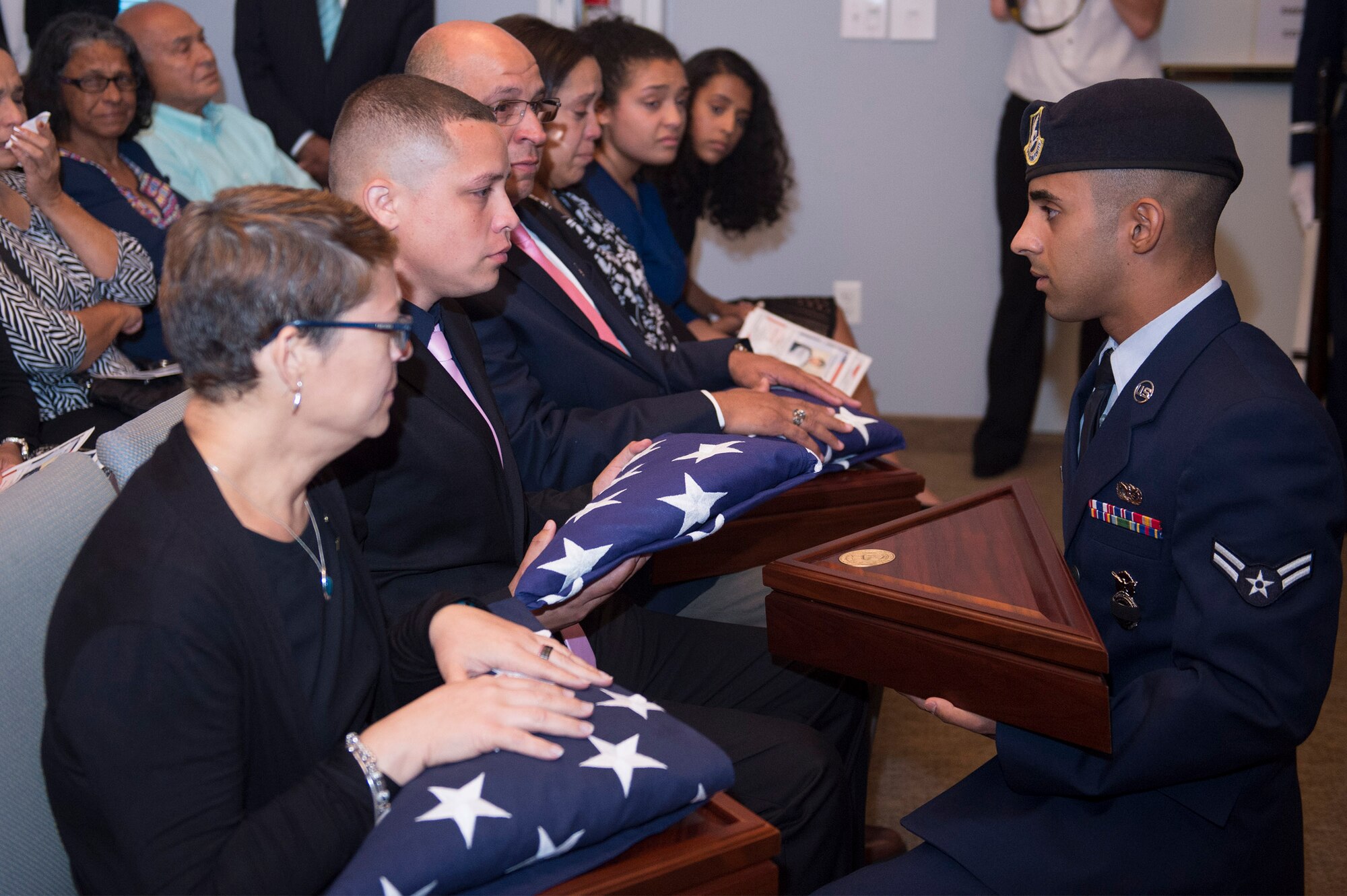 Airman 1st Class Jomalier Viera-Martinez, 18th Security Forces Squadron, Kadena Air Base, Japan, presents a flag to Miguel Angel Fuentes, Jr., brother of deceased Senior Airman Gabriel Antonio Fuentes Lebrón, 18th Security Forces Squadron, Kadena Air Base, Japan, during a funeral in Orange Park, Fla., June 1, 2017. Lebrón’s most recent accomplishment was being selected for promotion to Senior Airman Below The Zone, March 23, and was posthumously promoted on the day of his passing, May 19. He leaves behind his parents, older brother, Miguel Angel, sisters Michelle and Valerie, niece, Ileana, as well as countless other family members and friends. (U.S. Air Force photo by Senior Airman Greg Nash)