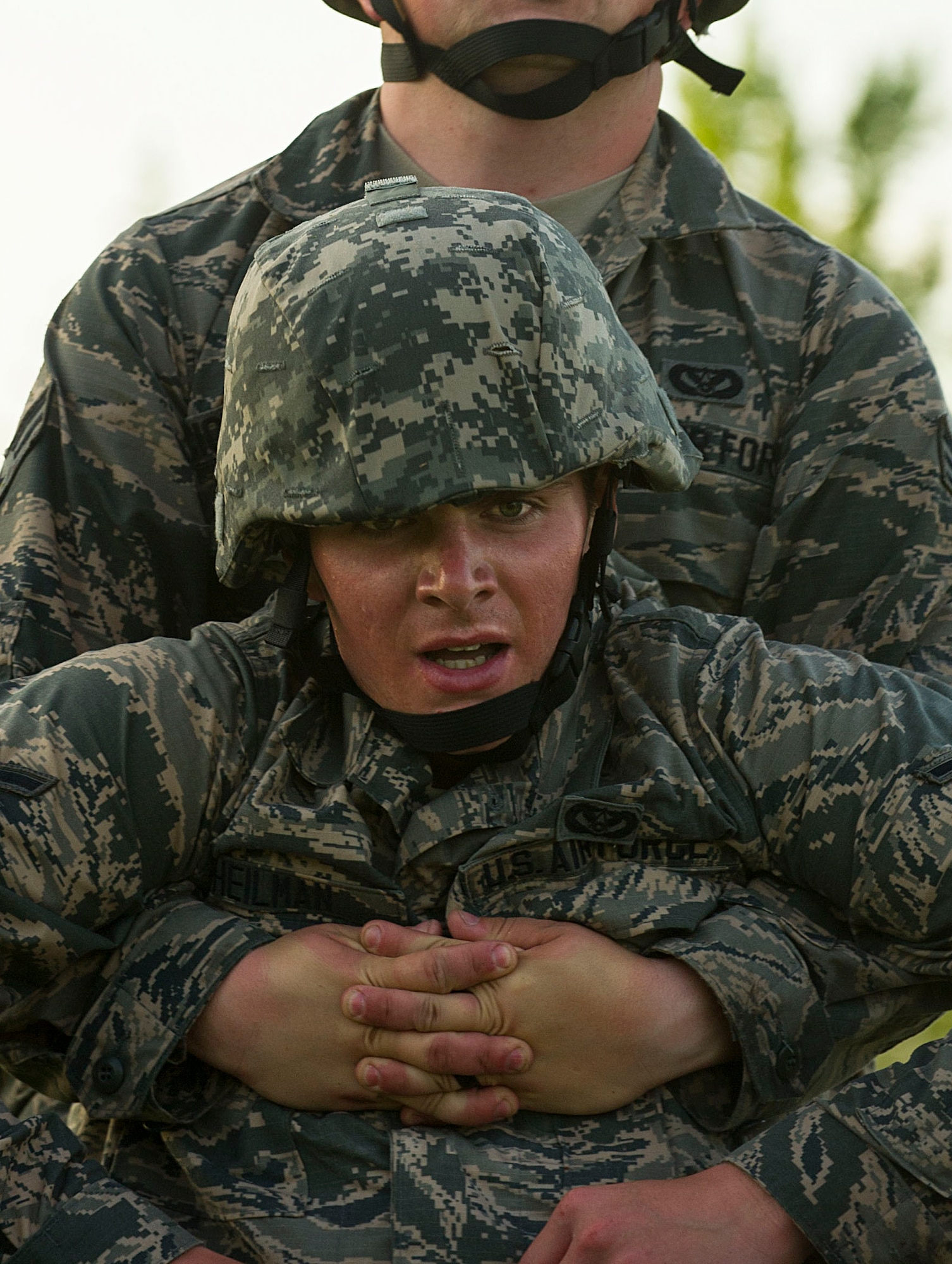 Airman Spencer Heilman, 5th Civil Engineer Squadron structural apprentice, is dragged by an Airman during an Expeditionary Training Day at Minot Air Force Base, N.D., June 1, 2017. During this final task of the day-long event, Airmen practiced Self-Aid and Buddy Care techniques during a relay. (U.S. Air Force photo/Senior Airman Apryl Hall)