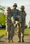 Airmen from the 5th Civil Engineer Squadron perform a “buddy carry” during an Expeditionary Training Day at Minot Air Force Base, N.D., June 1, 2017. During the final portion of the day-long training, Airmen completed a relay involving Self-Aid and Buddy Care techniques. (U.S. Air Force photo/Senior Airman Apryl Hall)