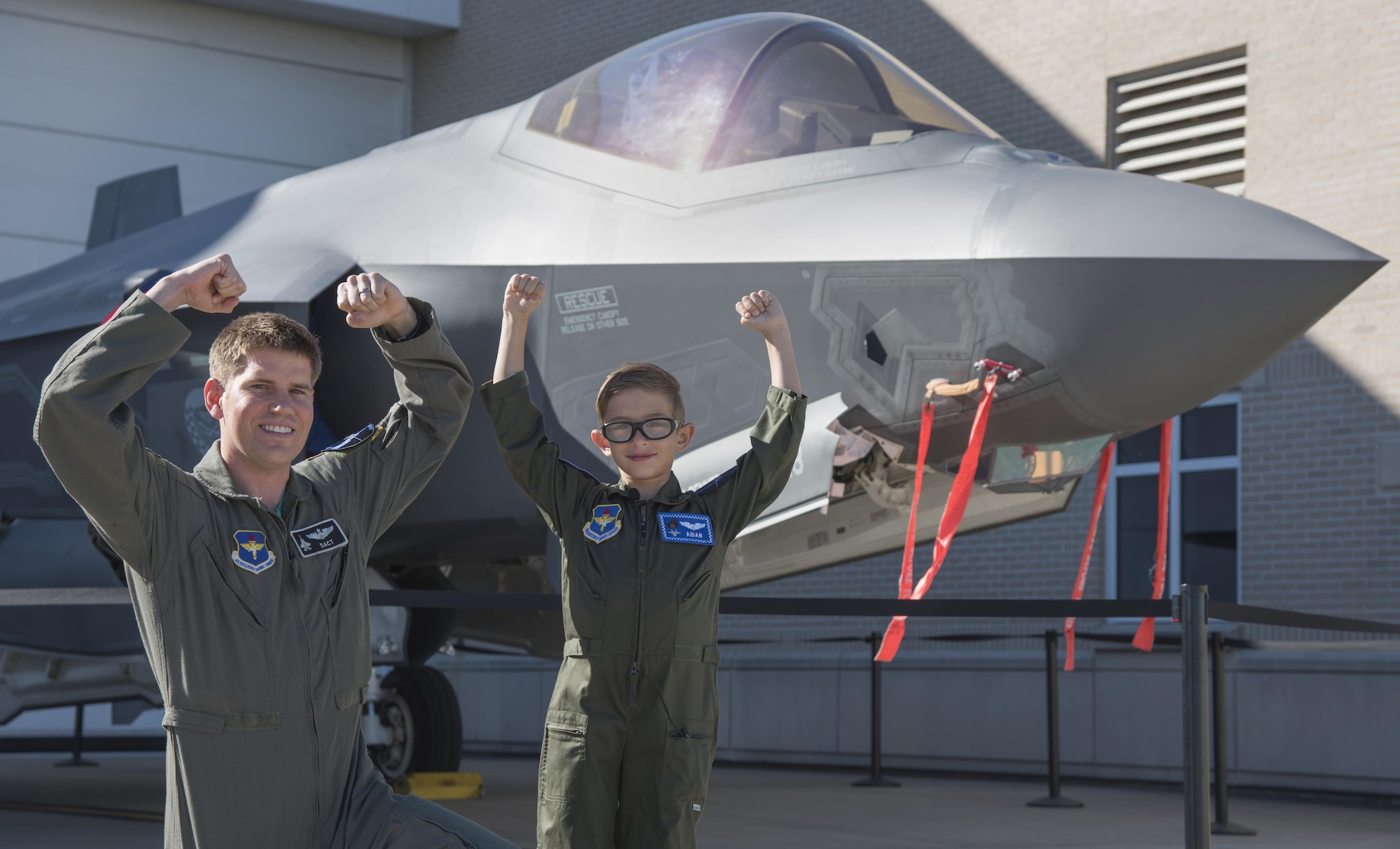 Aidan Flippo, pilot for a day candidate, shows his best "Gorillas" reenactment with Maj. Michael Krestyn, 33rd Operations Support Squadron, Director of Staff, May 25, 2017, at Eglin Air Force Base, Florida. Flippo, a 96th Test Wing dependent, was selected to be the 33rd Fighter Wing's pilot for a day. Aidan was born with Septo Optic Dysplasia which effects his eyes and kidneys. During his day, he met F-35 pilots, toured an aircraft, worked with aircraft maintainers and much more. (U.S. Air Force photo by Staff Sgt. Peter Thompson)
