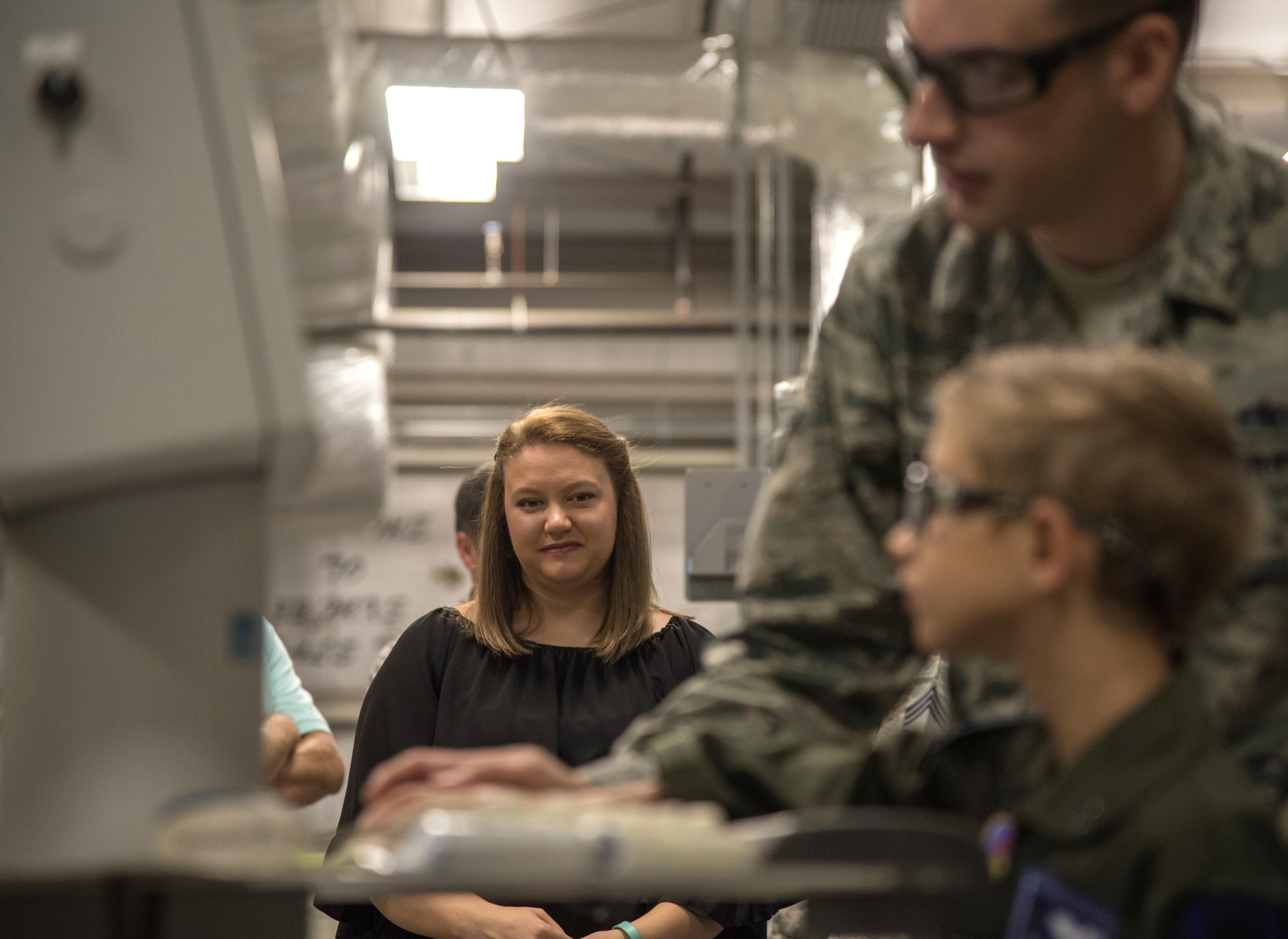 Brandy Flippo, mother of Aidan Flippo, looks on as Aidan, pilot for a day candidate, plots a pattern to be cut into sheet metal May 25, 2017, at Eglin Air Force Base, Florida. Flippo, a 96th Test Wing dependent, was selected to be the 33rd Fighter Wing's pilot for a day. Aidan was born with Septo Optic Dysplasia which effects his eyes and kidneys. During his day, he met F-35 pilots, toured an aircraft, worked with aircraft maintainers and much more. (U.S. Air Force photo by Staff Sgt. Peter Thompson)