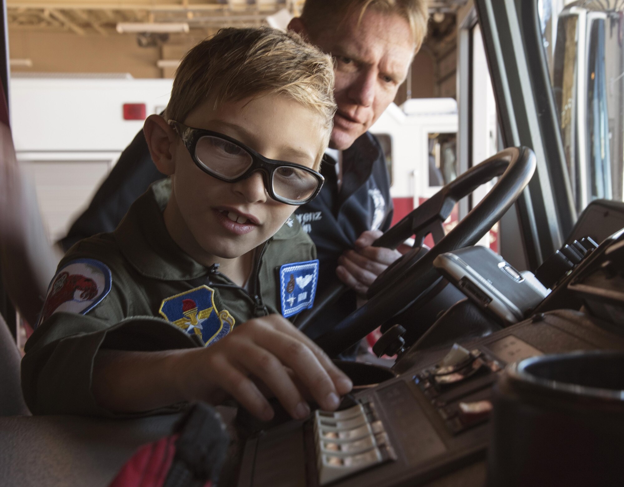 Aidan Flippo, pilot for a day candidate, pushes the siren in a fire truck May 25, 2017, at Eglin Air Force Base, Florida. Flippo, a 96th Test Wing dependent, was selected to be the 33rd Fighter Wing's pilot for a day. Aidan was born with Septo Optic Dysplasia which effects his eyes and kidneys. During his day, he met F-35 pilots, toured the aircraft, worked with aircraft maintainers and much more. (U.S. Air Force photo by Staff Sgt. Peter Thompson)