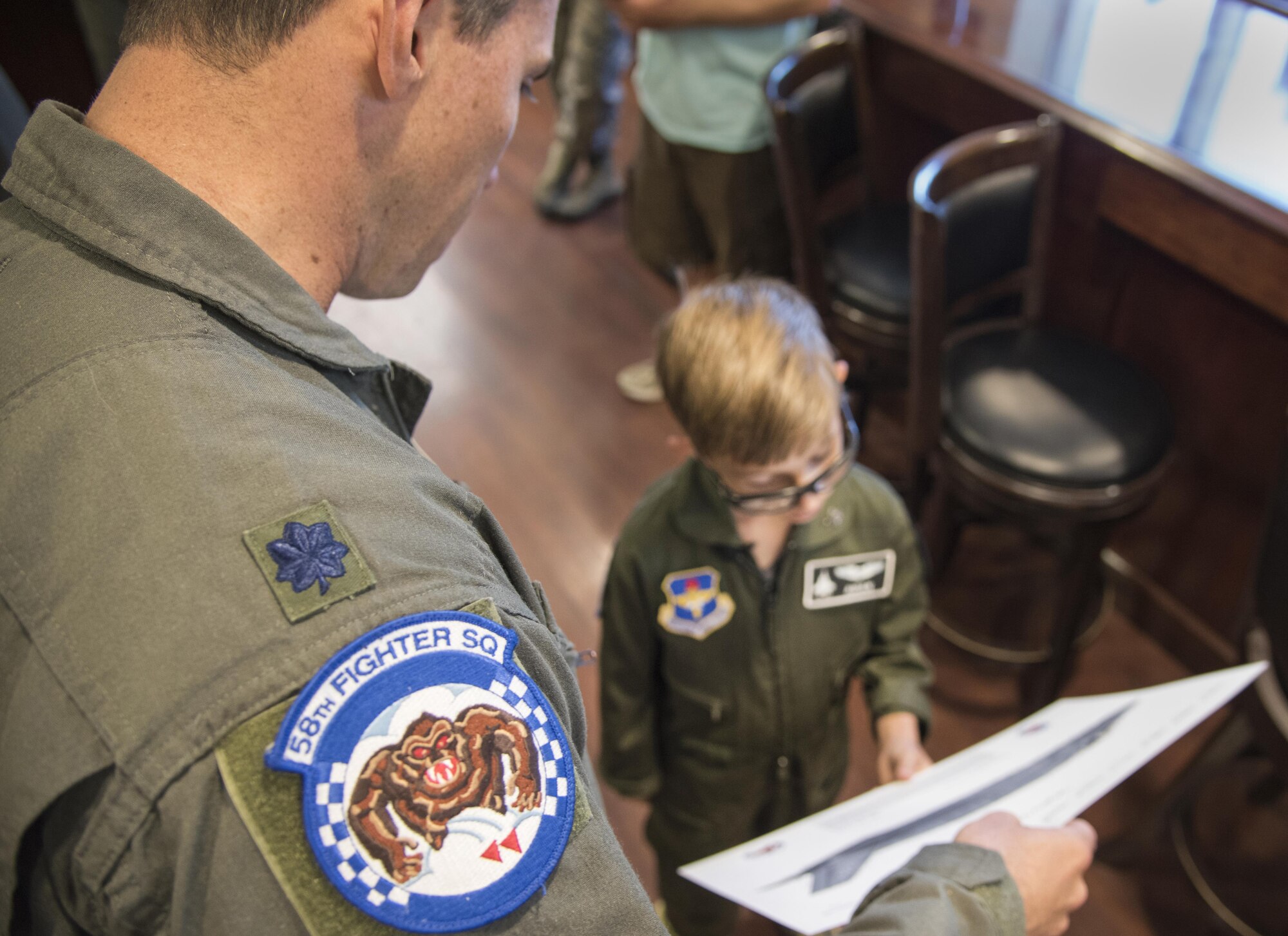 Lt. Col. Brad Bayshore, 58th Fighter Squadron commander, presents a signed lithograph of an F-35A Lightning II to Aidan Flippo, pilot for a day candidate, May 25, 2017, at Eglin Air Force Base, Florida. Flippo, a 96th Test Wing dependent, was selected to be the 33rd Fighter Wing's pilot for a day. Aidan was born with Septo Optic Dysplasia which effects his eyes and kidneys. During his day, he met F-35 pilots, toured an aircraft, worked with aircraft maintainers and much more. (U.S. Air Force photo by Staff Sgt. Peter Thompson)