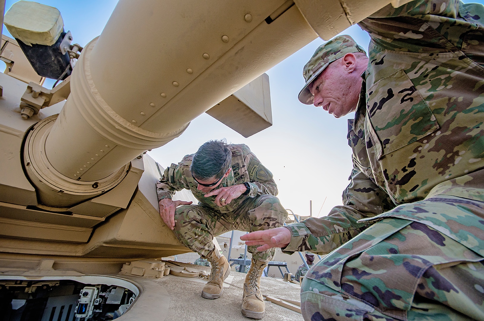 Sgt. 1st Class Frank Taylor (right), contract officer representative, Army Field Support Battalion-Kuwait explains combat enablers newly installed in an M1A2 System Enhancement Package-Version II Abrams tank to U.S. Central Command Commanding General, Army Gen. Joseph L. Votel during a tour of an Army Prepositioned Stocks-5 facility at Camp Arifjan, Kuwait, June 3. (U.S. Army photo by Justin Graff, 401st AFSB Public Affairs) (Photo Credit: Mr. Justin Graff (Rock Island Arsenal))