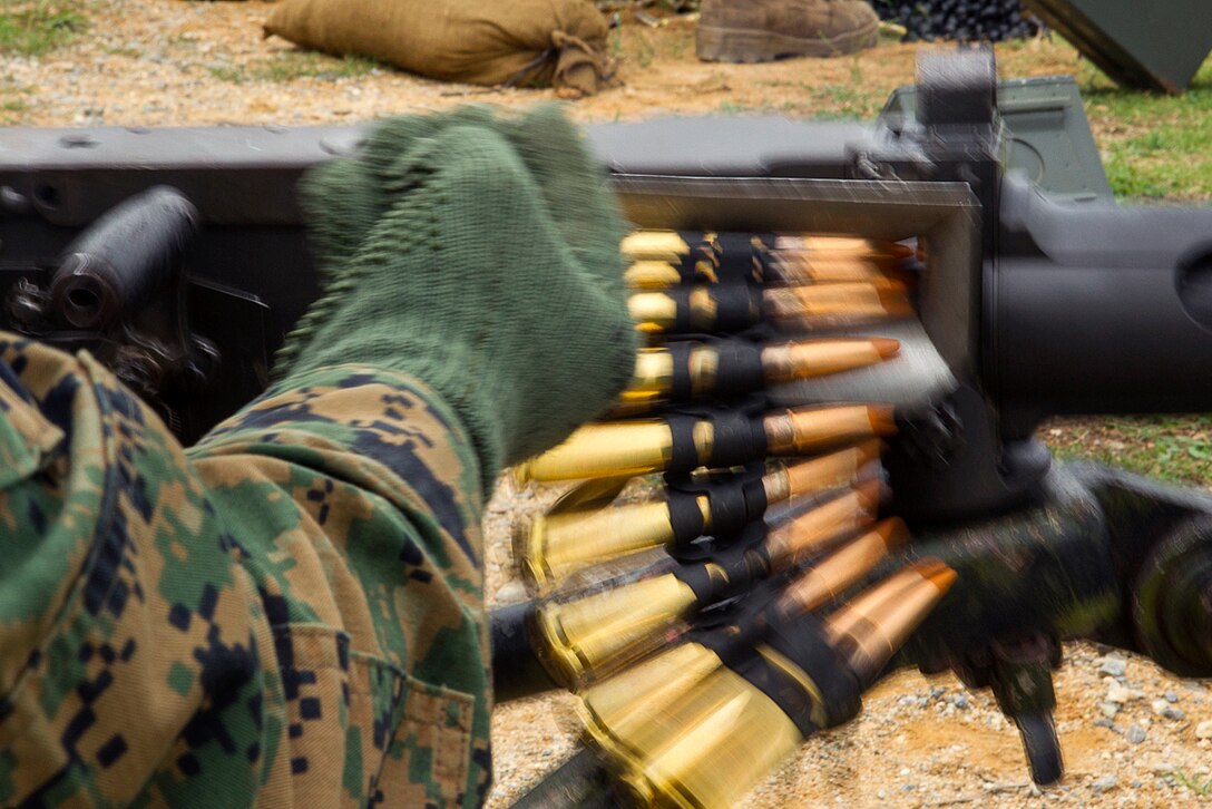 A Marine loads fifty caliber machine gun rounds feed into an M2 .50-caliber Browning machine gun during training at Camp Schwab, Okinawa, Japan, June 1, 2017. Marine Corps photo by Staff Sgt. T. T. Parish