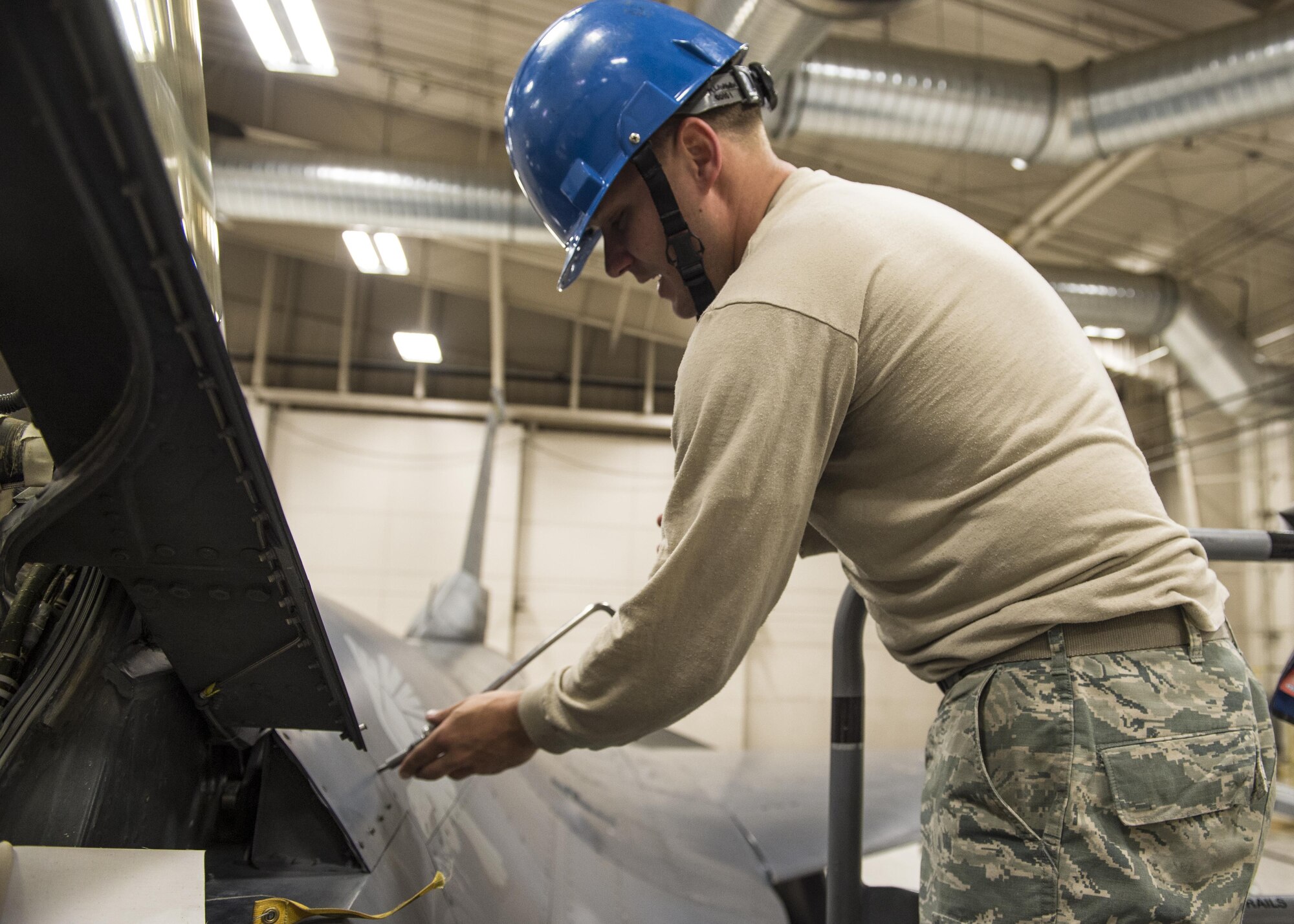 Staff Sgt. Mitchell Lawhorn, a 54th Maintenance Squadron egress systems craftsman, removes an aircraft panel before removing the canopy of an F-16 Fighting Falcon on March 13, 2017 at Holloman Air Force Base, N.M. Egress system specialists ensure that pilots can safely eject from aircraft in the event of an emergency. They perform scheduled and unscheduled maintenance on seats, hatches, canopies and modules to ensure pilots can safely eject if necessary. (U.S. Air Force photo by Senior Airman Emily Kenney)