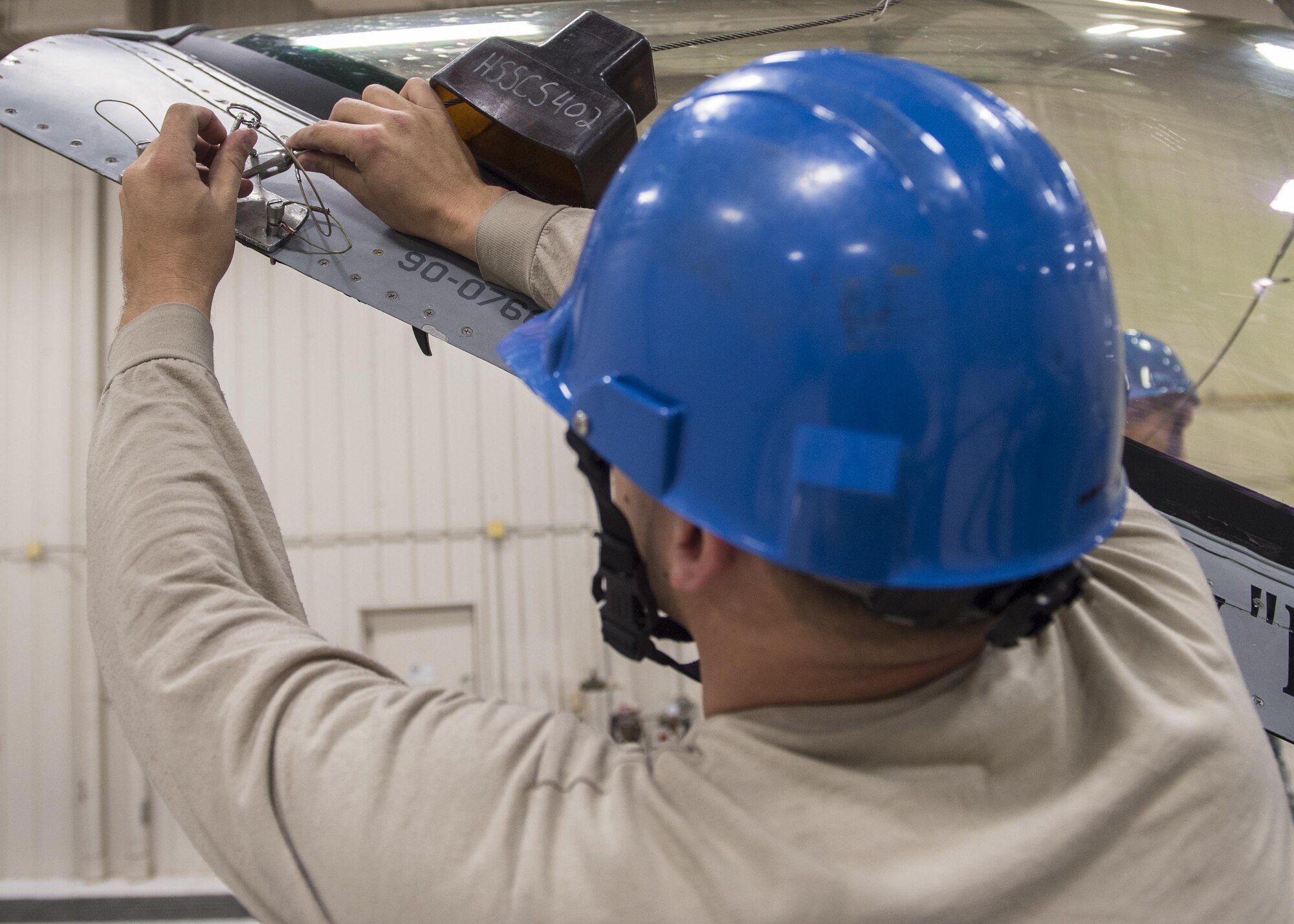 Staff Sgt. Mitchell Lawhorn, a 54th Maintenance Squadron egress systems craftsman, installs a canopy hoist adapter before removing the canopy of an F-16 Fighting Falcon on March 13, 2017 at Holloman Air Force Base, N.M. Egress system specialists ensure that pilots can safely eject from aircraft in the event of an emergency. They perform scheduled and unscheduled maintenance on seats, hatches, canopies and modules to ensure pilots can safely eject if necessary. (U.S. Air Force photo by Senior Airman Emily Kenney)